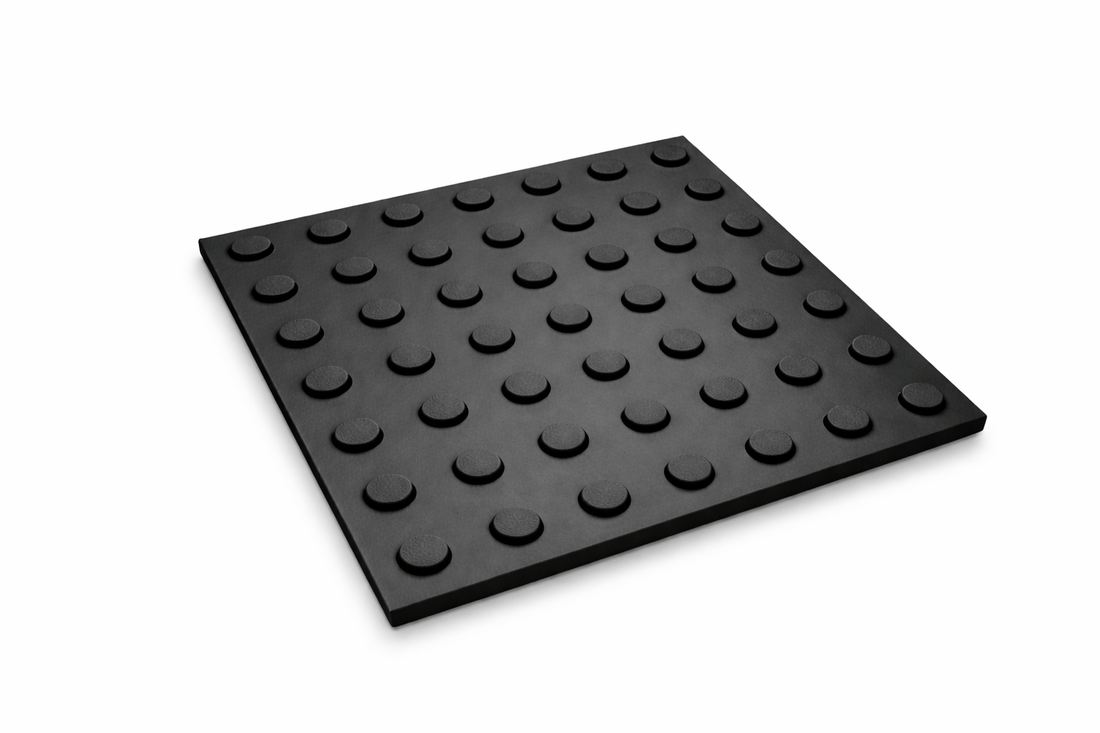 Black polymer tactile hazard warning tile with raised studs, 300mm x 300mm, for safety and accessibility.
